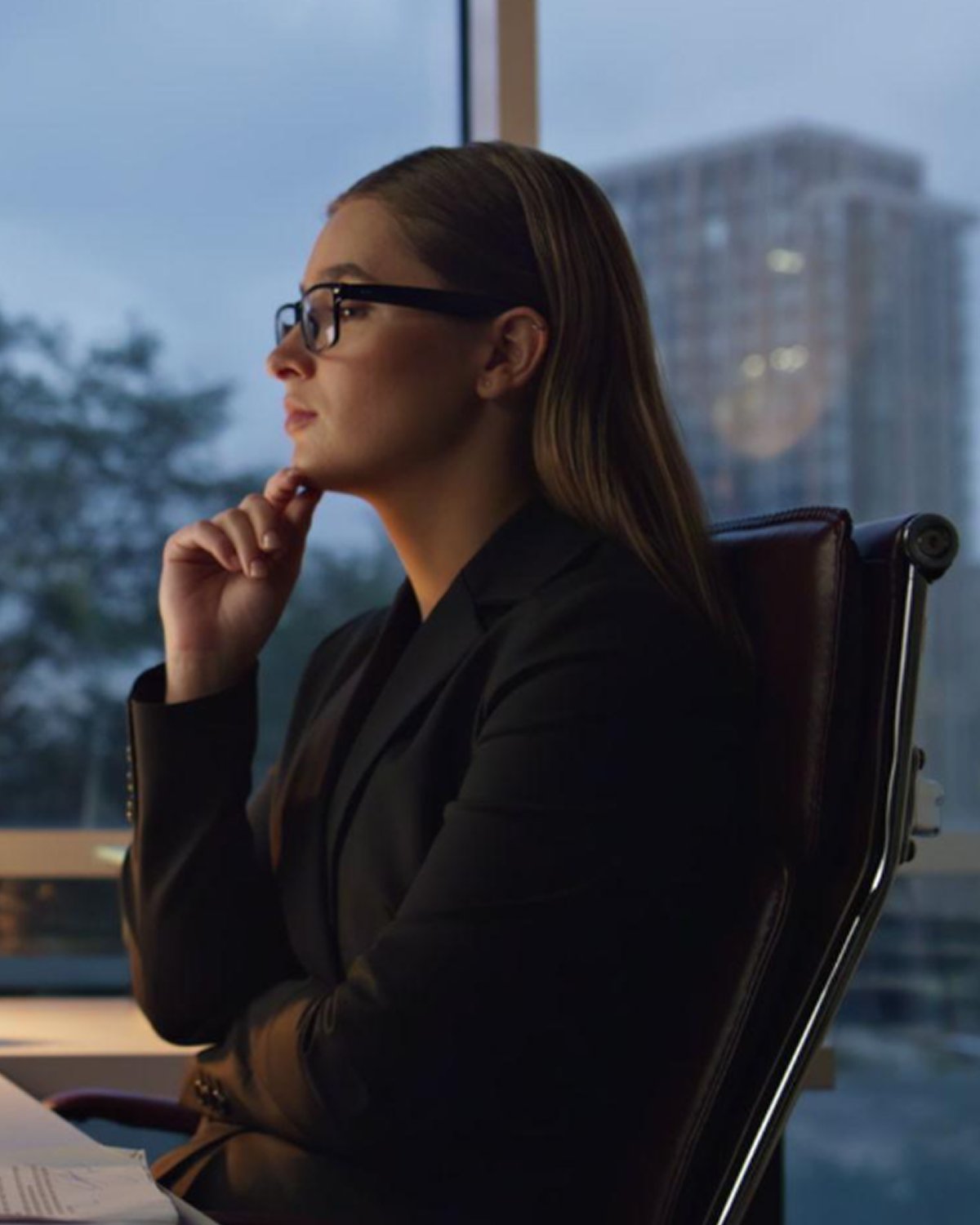 Brand strategist considering growth plans in a modern office